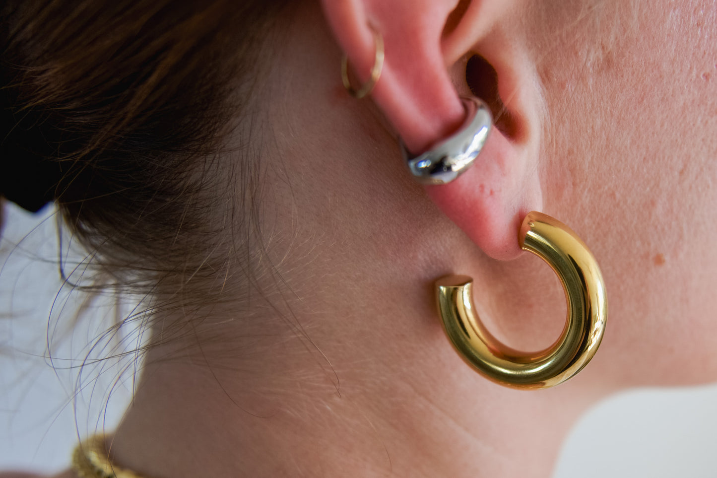 Chunky gold tube hoop earring worn on ear, 18k gold plated stainless steel, Mac&Coco South Africa