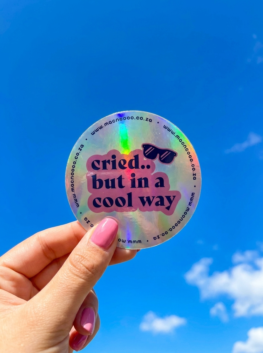 Holographic licence disc sticker held against blue sky