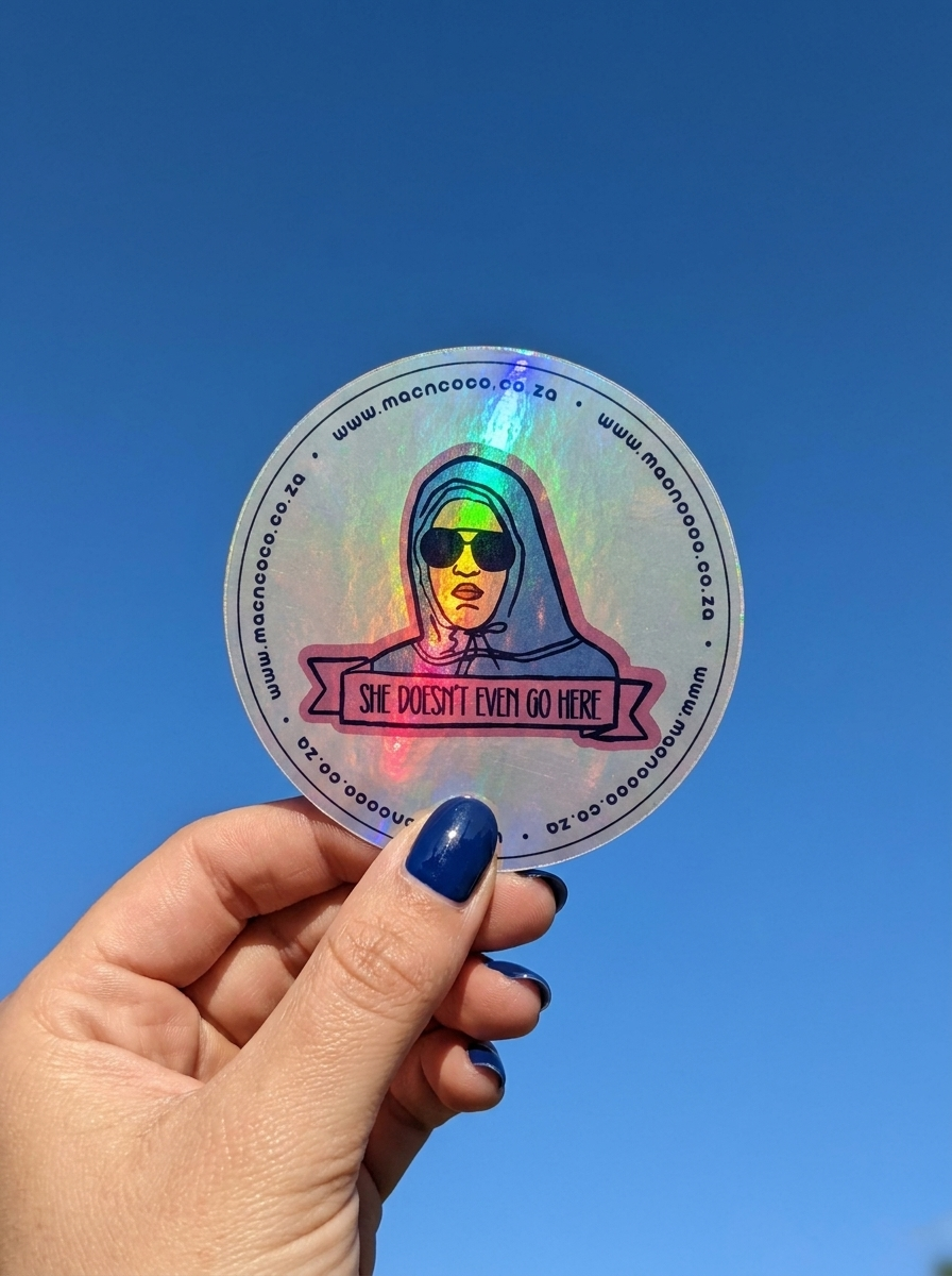 Holographic licence disc sticker held against blue sky