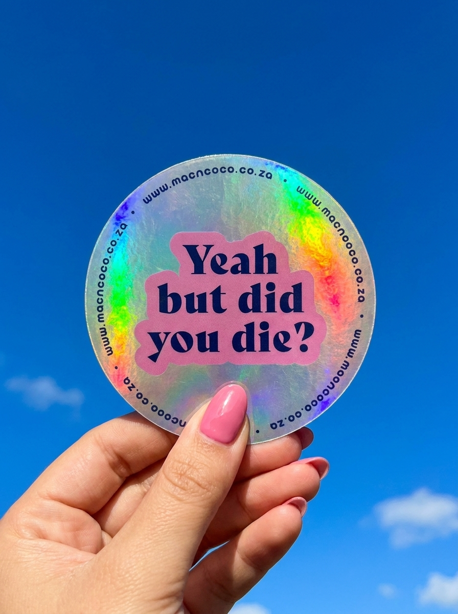 Holographic licence disc sticker held against blue sky