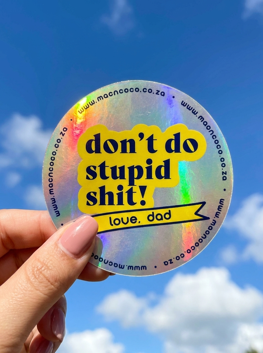 Holographic licence disc sticker held against blue sky