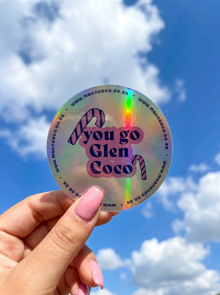 Holographic licence disc sticker held against blue sky